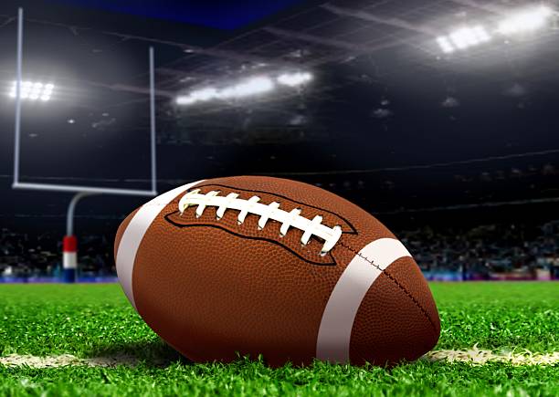 istock Football Ball on Grass in Stadium 515659231