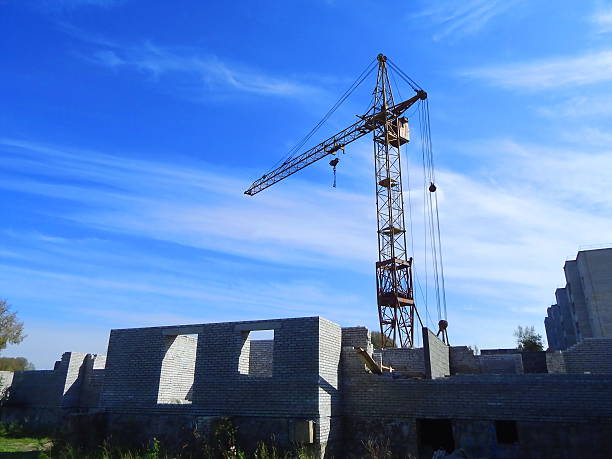 istock Construction crane at the construction of a brick house 515660757