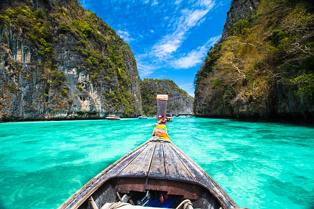 Wooden boat on Phi-Phi island, Thailand. Traditional wooden  boat in a picture perfect tropical bay on Koh Phi Phi Island, Thailand, Asia. phi phi islands stock pictures, royalty-free photos & images