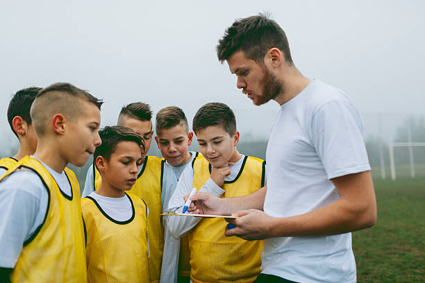 istock Kids Talking To Their Soccer Coach. 515671592