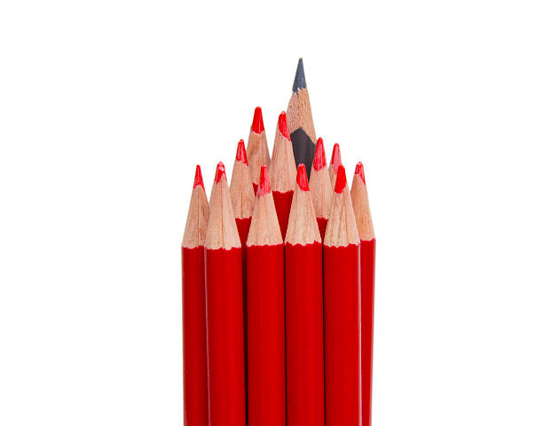 istock Black pencil standing out from the red pencils, isolated 515672844