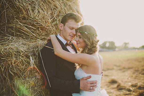 istock Bride and groom stand and hug at a field 515674172