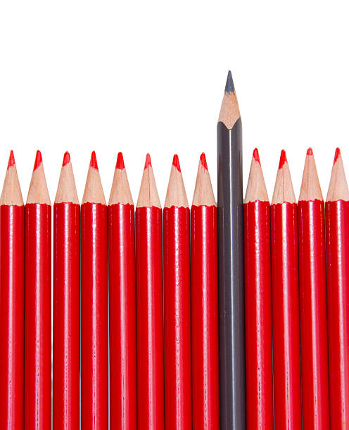 istock Black pencil standing out from the red pencils, isolated 515674404
