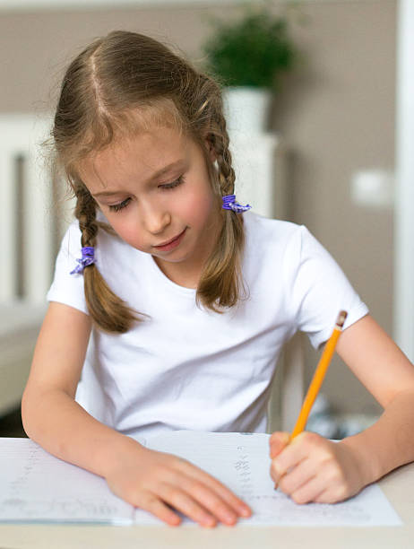 istock Cute little girl doing her homework for school. 515674608