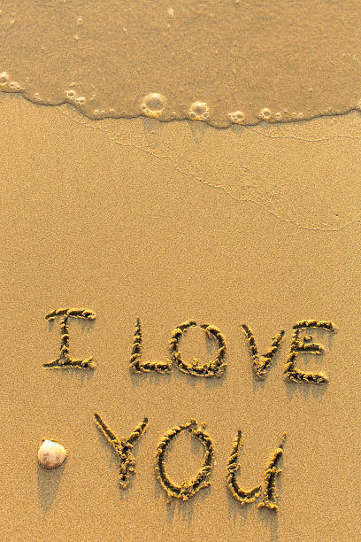 istock I Love You - drawn on sand beach 515675502