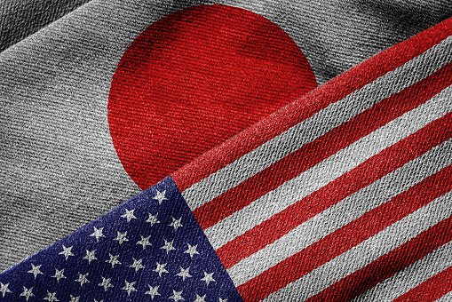 3D rendering of the flags of USA and Japan on woven fabric texture. Detailed textile pattern and grunge theme.