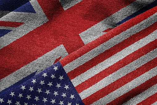 3D rendering of the flags of USA and UK on woven fabric texture. Detailed textile pattern and grunge theme.
