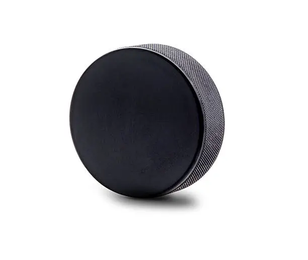 A black hockey puck in upright position isolated on white background with copy space.