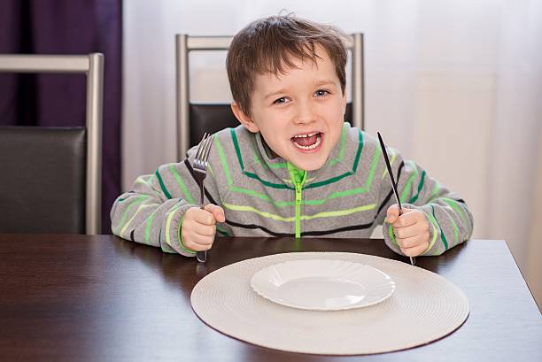 istock Happy smiling boy child waiting for dinner. 515678182