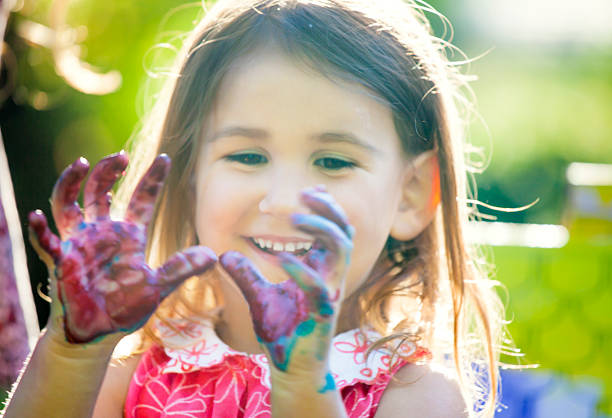istock Cute little girl with finger paint 515682004