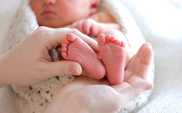 istock Baby Feet In Mother Hands 515682560
