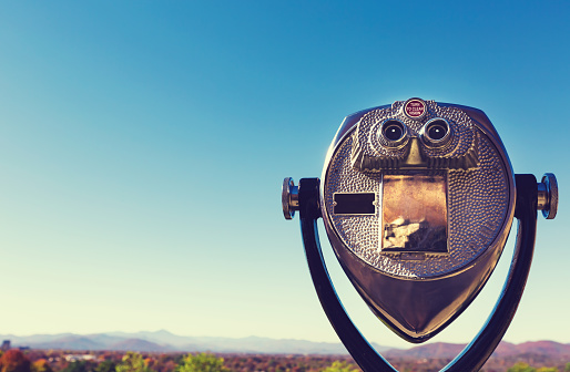 Coin-operated binoculars looking out over an autumn landscape