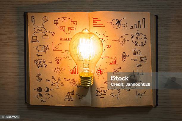 Vintage Book Of Business Graph And Light Bulb Stock Photo - Download Image Now - Book, Choosing, Close-up