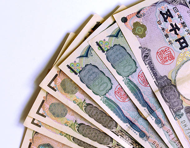 Japanese Yen currency partial view of bills and coins Japanese Yen currency partial view of bills and coins nikkei index stock pictures, royalty-free photos & images