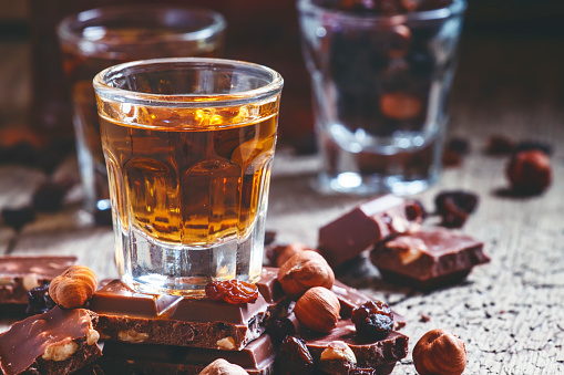 Milk chocolate with nuts and raisins with dark Jamaican rum, selective focus