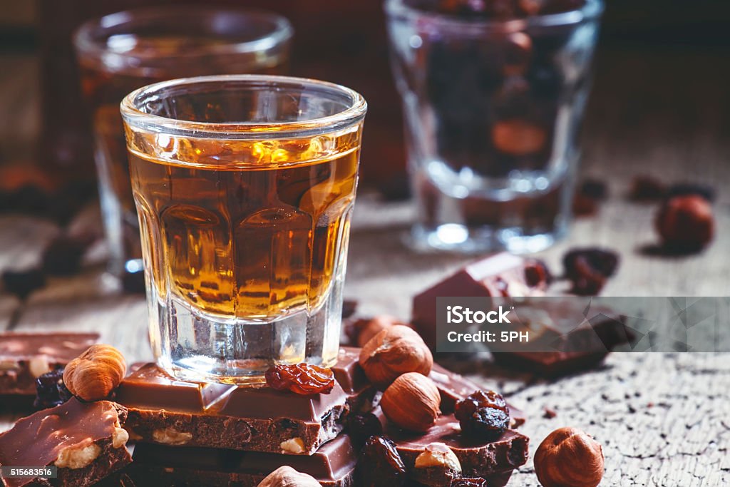 Milk chocolate with nuts and raisins with dark Jamaican rum Milk chocolate with nuts and raisins with dark Jamaican rum, selective focus Chocolate Stock Photo