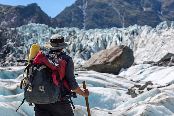 istock Man with Backpack Hiking on Fox Glacier, New Zealand 515683889