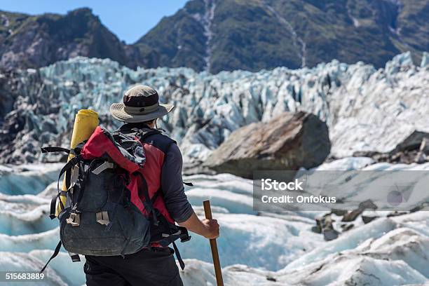 Man With Backpack Hiking On Fox Glacier New Zealand Stock Photo - Download Image Now
