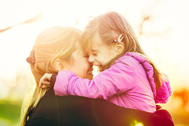 istock Mother and daughter hugging outdoors closeup 515684818