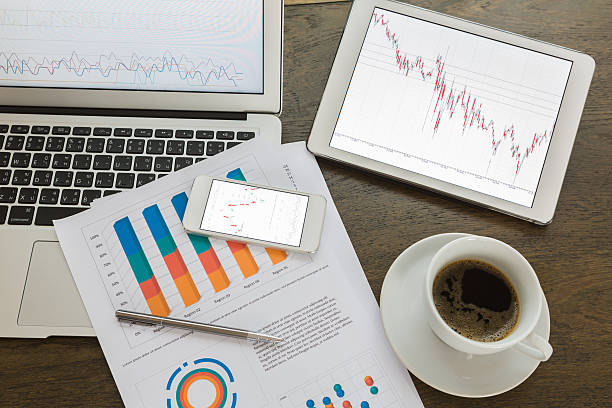 istock Laptop, tablet , smartphone and coffee cup with financial docume 515685045