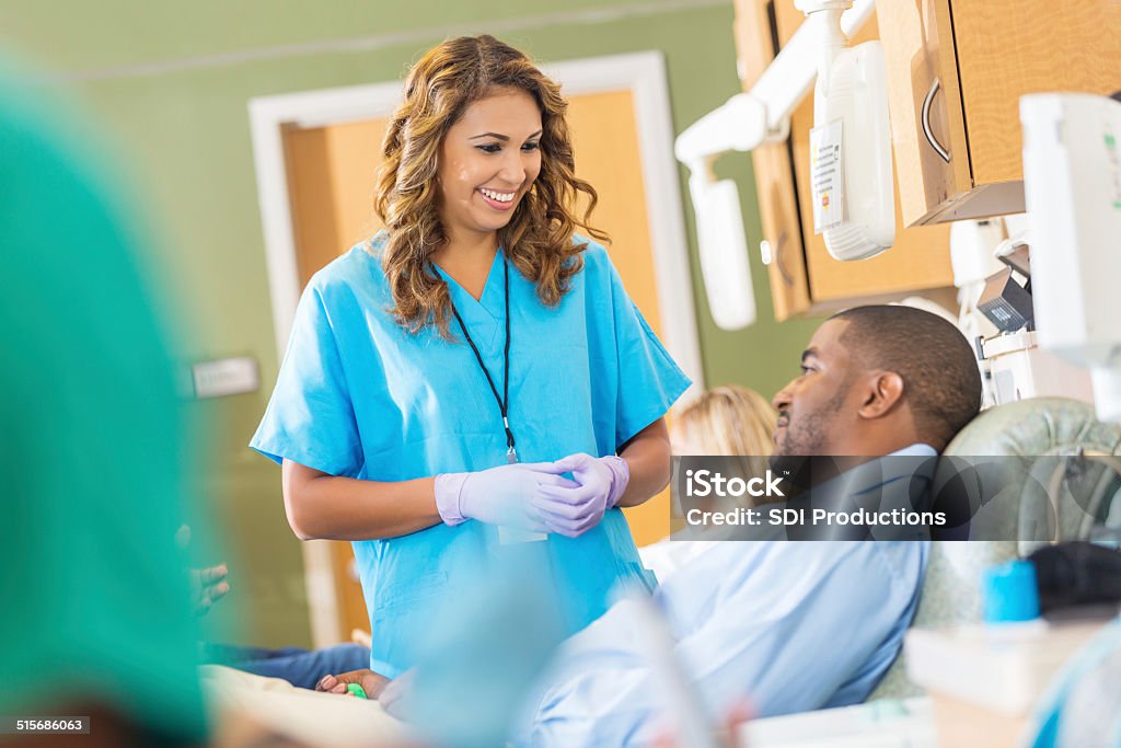 Friendly nurse helping patient in hospital blood bank center Patient Stock Photo