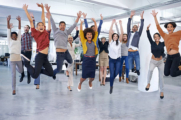 They'll jump at the chance to help you out Shot of office staff jumping fun stock pictures, royalty-free photos & images