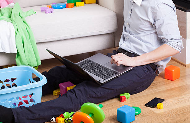 istock Dad sitting on the floor and uses a laptop 515701395