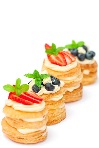 istock homemade  puff pastry stuffed with cream and berries on white 515702172