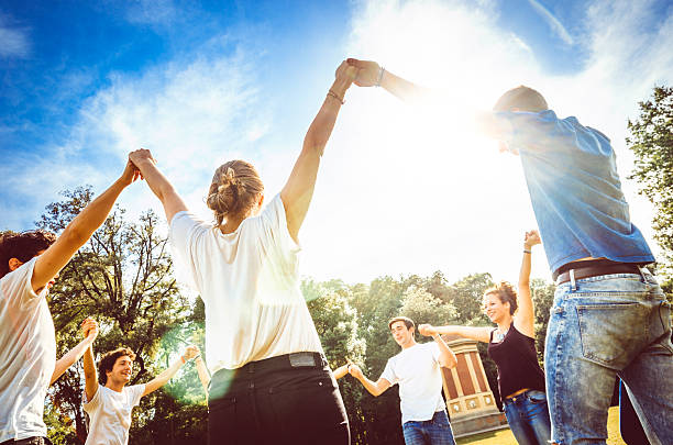 istock Friends holding hands in the park 515702289