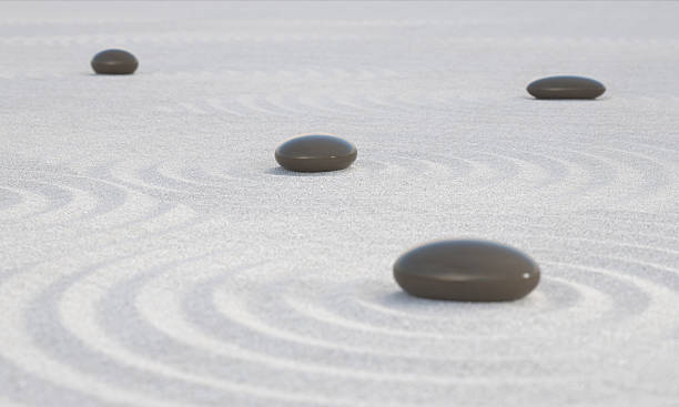 Dark Zen stones on a wide sands stock photo