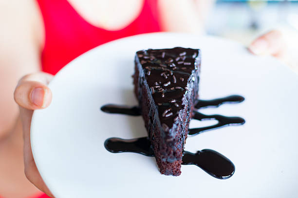 istock Sliced chocolate cake with melted sauce on a white plate 515703140