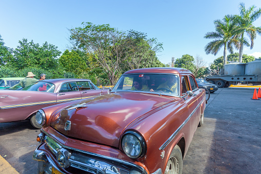 Cienfuegos, Cuba - March 23,  2012: Rural road parking with retro Ford car