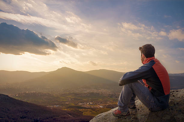 istock Man on top watching a beautiful sunrise in the village 515704042