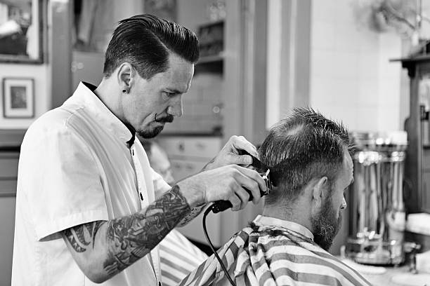 istock barber working with customer at barbershop 515704355