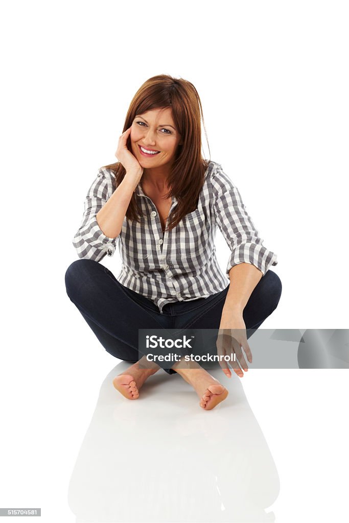 Stylish woman sitting relaxed Portrait of stylish woman sitting relaxed on white background Sitting On Ground Stock Photo