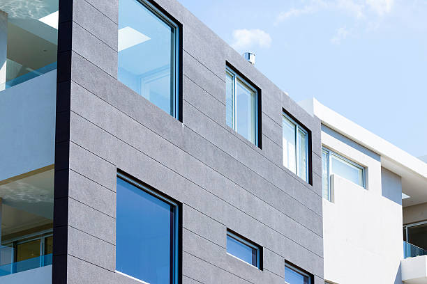 Closeup modern apartment building against blue sky, copy space