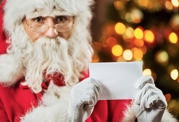 istock Santa Claus holding greeting card. 515705049
