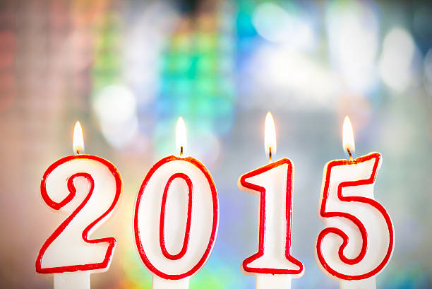 istock New Year 2015 birthday candles with colorful boke background 515705713