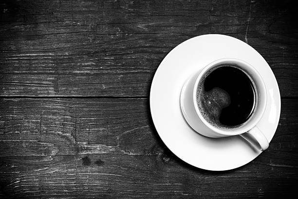 istock White cup of coffee on old wooden table. Toned 515707520