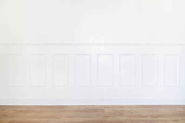 istock Empty white room with parquet floor and wood trimmed wall 515708318