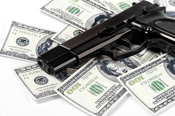 waffe und geld - currency crime gun conflict stock-fotos und bilder