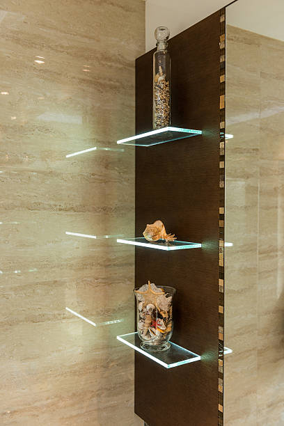 Glass shelf in bathroom with ornaments and decorations, earth tones