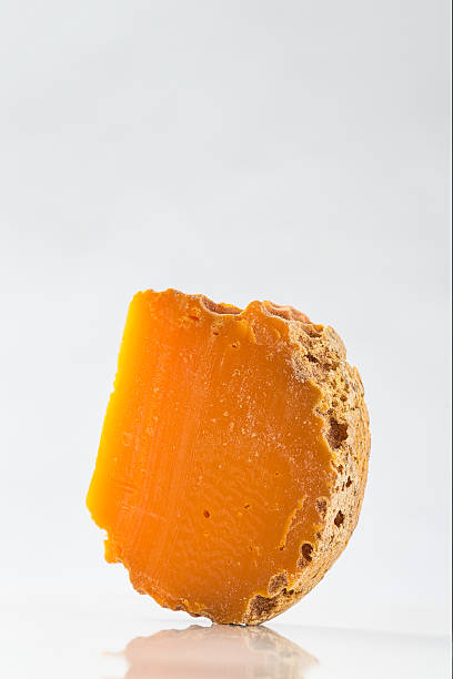 istock Portion of Mimolette Cheese isolated on white background 515713090