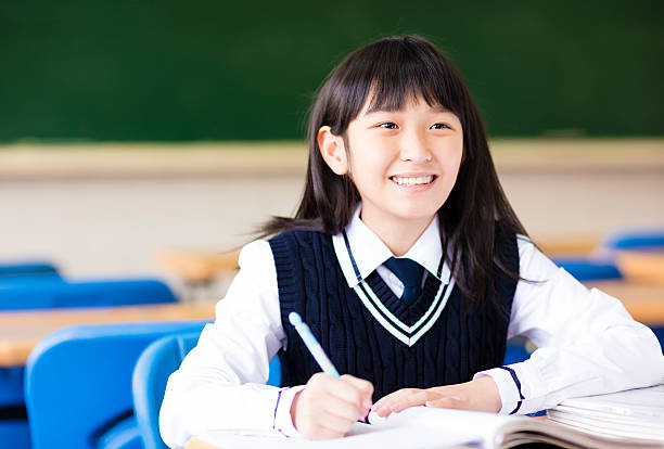 istock happy pretty  student girl with books in classroom 515716800