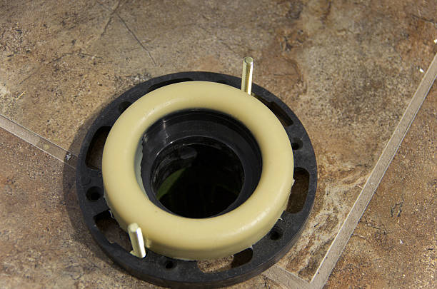 New Toilet Wax Gasket View of the wax gasket used to seal the base of a toilet, during new house construction. gasket stock pictures, royalty-free photos & images