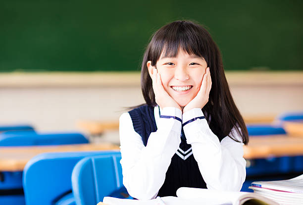 istock happy pretty  student girl with books in classroom 515716978