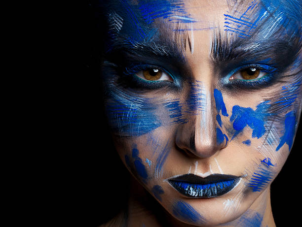 istock girl in blue paint on his face 515717006