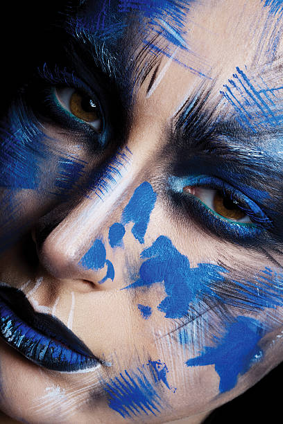 istock girl in blue paint on his face 515717400