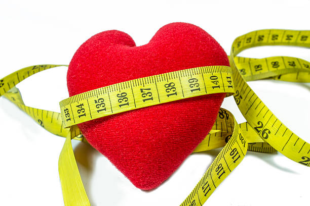 istock Red heart with yellow tape measure. Clipping path included. 515719115