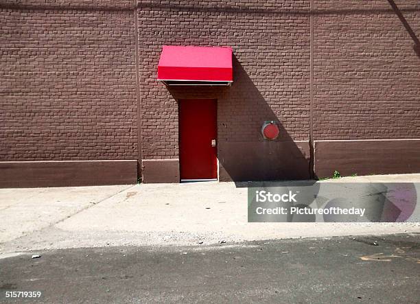 Side Red Brick Building Red Door And Red Awning Daytime Stock Photo - Download Image Now
